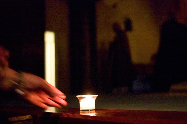 A worshipper puts down a candle in front of the altair during a memorial service for the victims of the March 2011 earthquake and tsunami in Japan at Zenshuji Soto Mission in Little Tokyo in Los Angeles, Calif., Sunday, March 20, 2011.