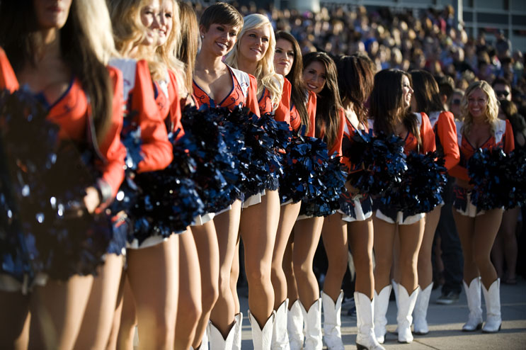 Cheerleaders fire up the crowd of potential contesters before the American Idol Season 11 auditions at Invesco Field at Mile High in Denver, Friday, July 29, 2011.