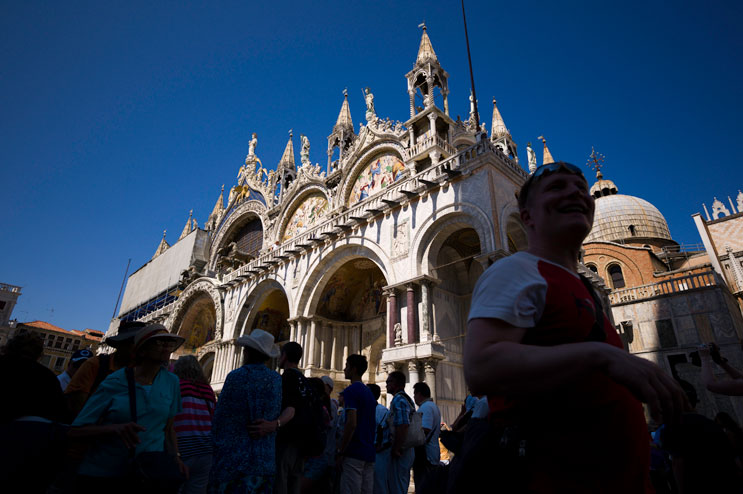 Hordes of tourists crowd the area in front of the Basilica di San Marco at St. Mark's Square in Venice, Italy, Wednesday, June 27, 2012. The Piazza St. Marco and its surrounding buildings are the most famous architectural landmark in Venice.